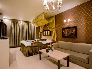 a hotel room with a bed and a couch at Hotel Christmas Night at the Opera (Love Hotel) in Nishihara