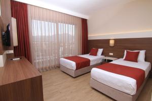 Postel nebo postele na pokoji v ubytování Sunway Club Otel