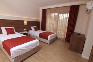 Postel nebo postele na pokoji v ubytování Sunway Club Otel