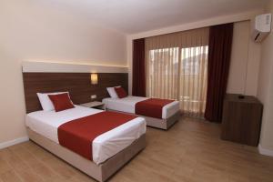 Postel nebo postele na pokoji v ubytování Sunway Club Otel