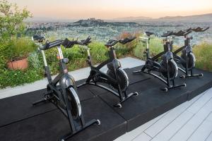 a row of exercise bikes on a table with a view at St George Lycabettus Lifestyle Hotel in Athens