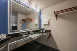 a bathroom with a sink and a large mirror at Stratford House Inn in Edmond +25 photos
