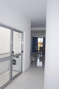 a living room with a glass door and a dining room at AL Guesthouse in Praia