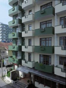 a tall building with green balconies on it at Lafala Hotel & Service Apartment in Colombo