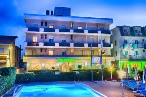 a hotel with a swimming pool in front of a building at Hotel Meritime in Bellaria-Igea Marina