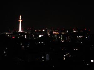 a view of a city at night with the eiffel tower at Ryokan Ryokufuso in Kyoto