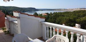 a balcony with chairs and a view of a lake at Apartments Vila Lavanda in Omišalj