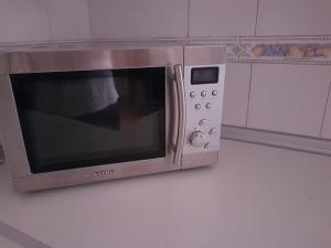 a microwave oven on a wall in a kitchen at Apartamento CabezoDoce in Calahorra