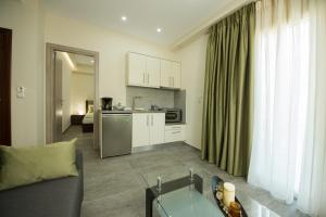 a living room with a couch and a kitchen at Tresor Apartments in Parga