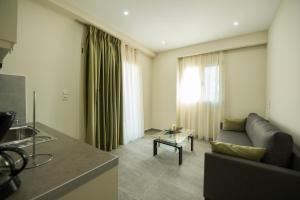 a living room with a couch and a table at Tresor Apartments in Parga