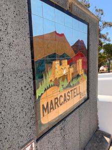 a sign on the side of a wall with a picture of maraccilla at Casa Delores in Playa Blanca