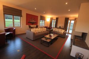 a living room with a couch and a table at Domaine de La Noiseraie in Rhisnes
