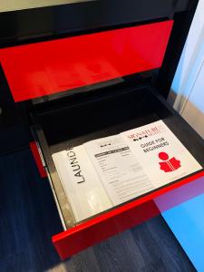 a red box with a book in it at Signature Lux Hotel by ONOMO, Foreshore in Cape Town