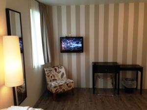 TV at/o entertainment center sa Torget Hotell