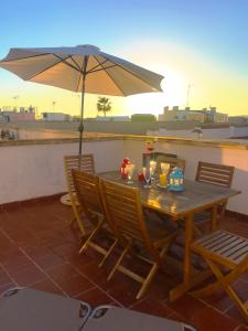 a wooden table with an umbrella on a patio at 28 Townhouse 200mts from sea/beach in Palma de Mallorca
