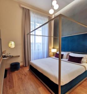 a bedroom with a large bed and a large window at Renascentia in Florence in Florence