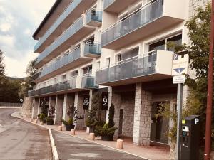 a large building with balconies on the side of a street at Residence The Catalogne in Font-Romeu