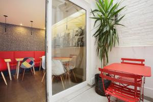 a dining room with a red table and chairs at Hotel Auguste in Paris
