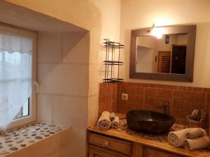 a bathroom with a sink and a tub and a mirror at LA MESONNETTA in Soulignonne +70 photos