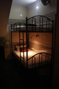 two bunk beds in a small room with a light at First IN in Madgaon