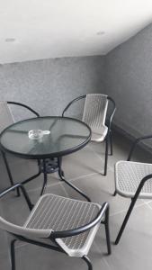 a glass table and chairs in a room at Ferienwohnung Petrovic in Krimovice +7 photos