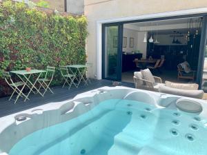 a hot tub in the middle of a patio at La Maison Odeia Bordeaux Centre in Bordeaux