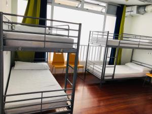 a bedroom with two bunk beds and a window at Albergue la Estacion in Santiago de Compostela