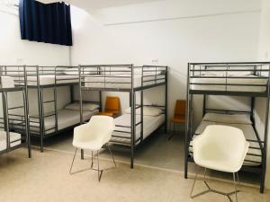 a row of bunk beds in a room at Albergue la Estacion in Santiago de Compostela
