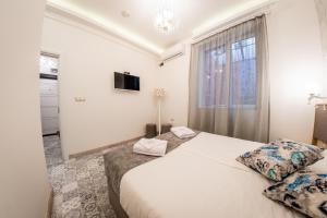 a bedroom with two beds and a window at Sofia Pearl Life Apartment - No Window Apartment in Sofia
