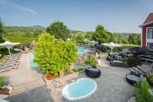 an overhead view of a pool with lounge chairs and a resort at Estrimont Suites & Spa in Magog-Orford