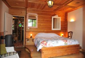 a bedroom with a bed in a wooden room at Les Fous de Bassans in Poullan-sur-Mer