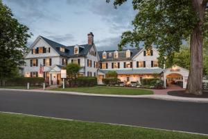 a large white house on a street at Inn on Boltwood in Amherst