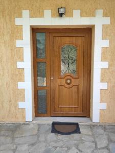 a wooden door with a window on a house at Elpida Apartment in Limenas