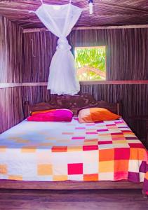 a bedroom with a bed with a dress on it at Reva Castel in Nosy Be