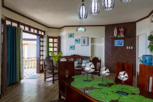 a dining room with a table with green leaves on it at Casa dela Playa (House by the Beach) in Dipolog +15 photos