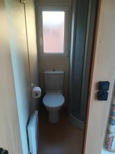 a small bathroom with a toilet and a window at Agri Village Pavia in Certosa di Pavia