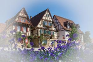 a building with purple flowers in front of it at Pension Amthof in Oberderdingen