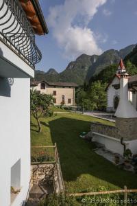 a view from the balcony of a house with a yard at Il Capriolo Felice - Agriturismo in Lastebasse