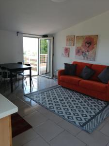 a living room with a red couch and a table at La Collina del Riccio in Ortona +53 photos