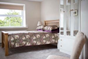 1 dormitorio con cama y ventana en Old Schoolhouse B and B en Enniskillen