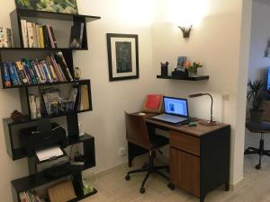 an office with a desk with a laptop computer on it at French Riviera Condo 4 Rent in Marina Baie des Anges in Villeneuve-Loubet