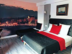 a bedroom with a bed with a view of a city at Resothel Le Gabian in Saint-Laurent-du-Var