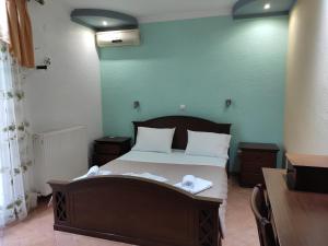 a bedroom with a bed with towels on it at Elpida Apartment in Limenas