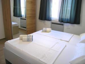 Posteľ alebo postele v izbe v ubytovaní Apartmani Krajinovic