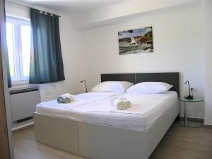 Posteľ alebo postele v izbe v ubytovaní Apartmani Krajinovic