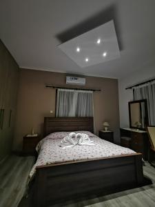 a bedroom with a bed with a robe on it at Kalamospito Holiday House in Kalokhorio