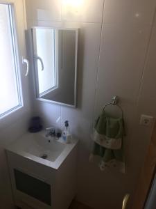 a bathroom with a sink and a mirror at Casa individual barrio las escuelas in Hazas de Cesto
