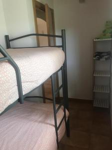 a bunk bed in a room with a shelf at Casa individual barrio las escuelas in Hazas de Cesto