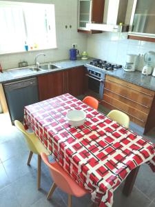a kitchen with a table with aaid table cloth on it at Casa Luminosa in Carrapateira