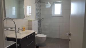 Kúpeľňa v ubytovaní Apartmani Krajinovic + 31 fotografií